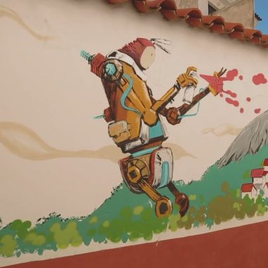 A giant robot spraypaints houses in this mural.