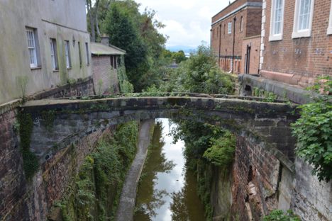 The footbridge was used to take prisoners from the City gaol on site of No.1 Upper Northgate Street (qv) to the former Chapel of St John in the south wing of the Bluecoat School.