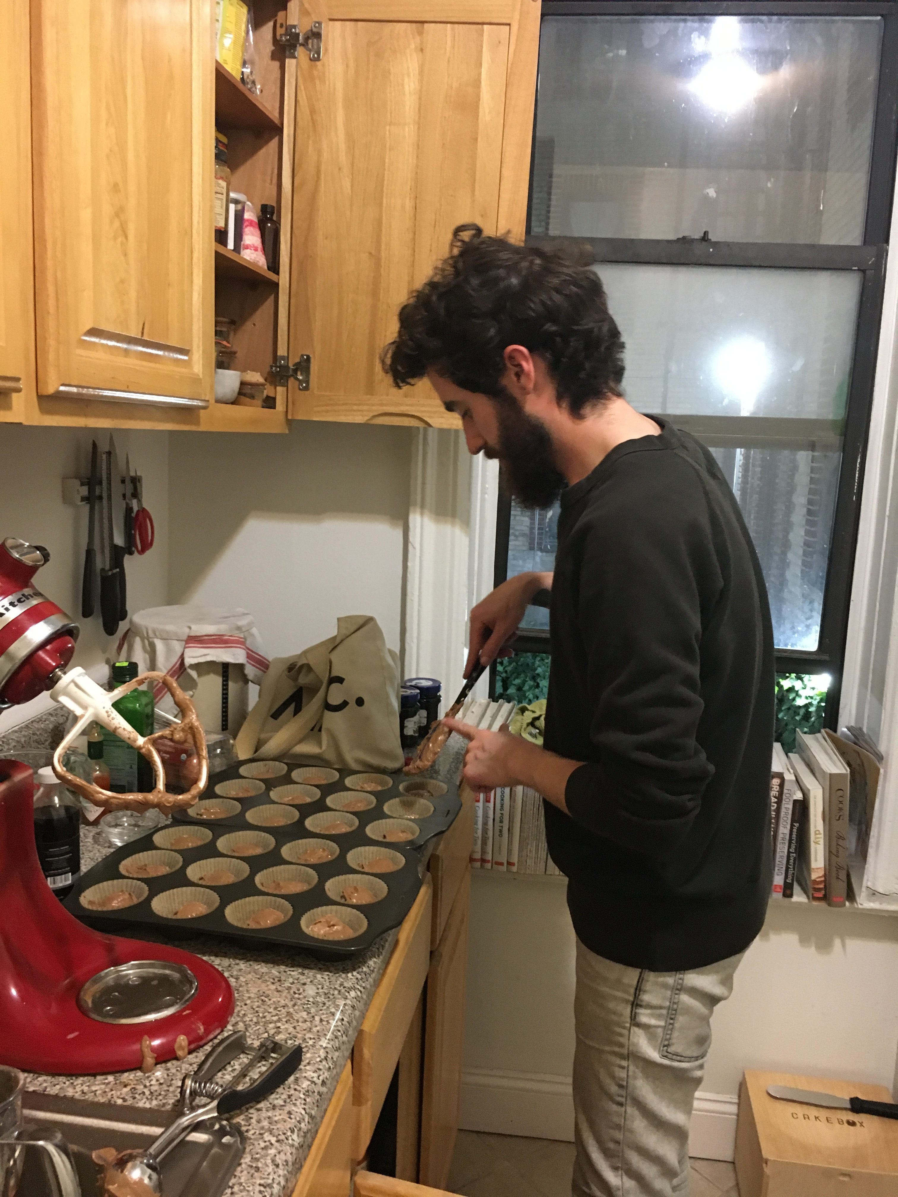 Chef Olmstead dollops the batter into a well-assembled muffin tin.