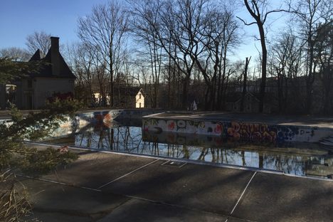Abandoned pool with Gate House in the distance