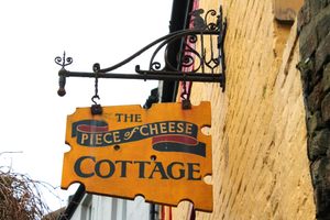 The Piece of Cheese Cottage sign