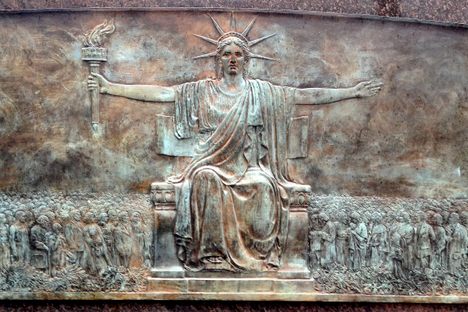 Bronze plaque showing Larado Taft's seated Statue of Liberty