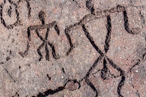 Petroglyphs of two people in the Waikoloa Petroglyph Field.  These are potentially Hawaiʻi's most famous petroglyphs. 