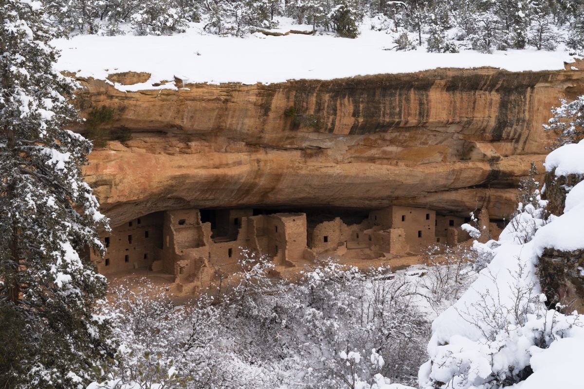 Fresh snow accentuates a warm ancient Puebloan city.