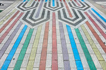 The Rainbow Crosswalk is paved with a familiar Art Deco pattern in colors chosen from Leonard Horowitz's palette.
