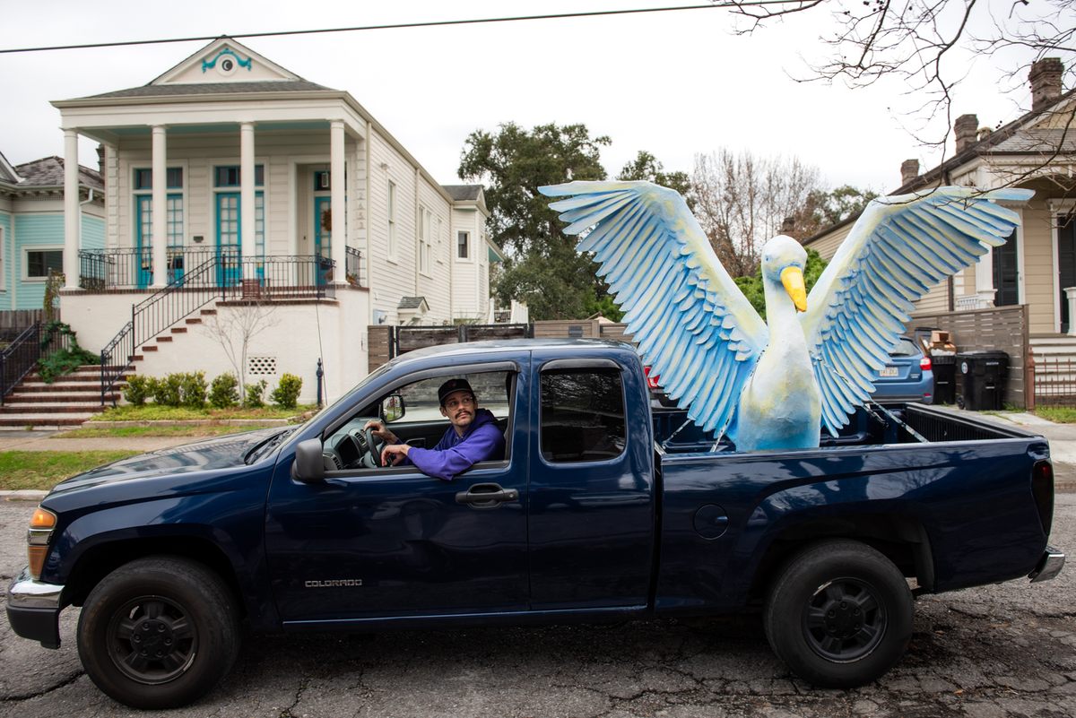 Travis Keene transports an egret prop for the “Birds of Bulbancha” house float.