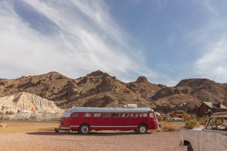 Restored and rusting vintage cars, trucks, and buses dot the landscape