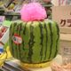 A square watermelon on display.