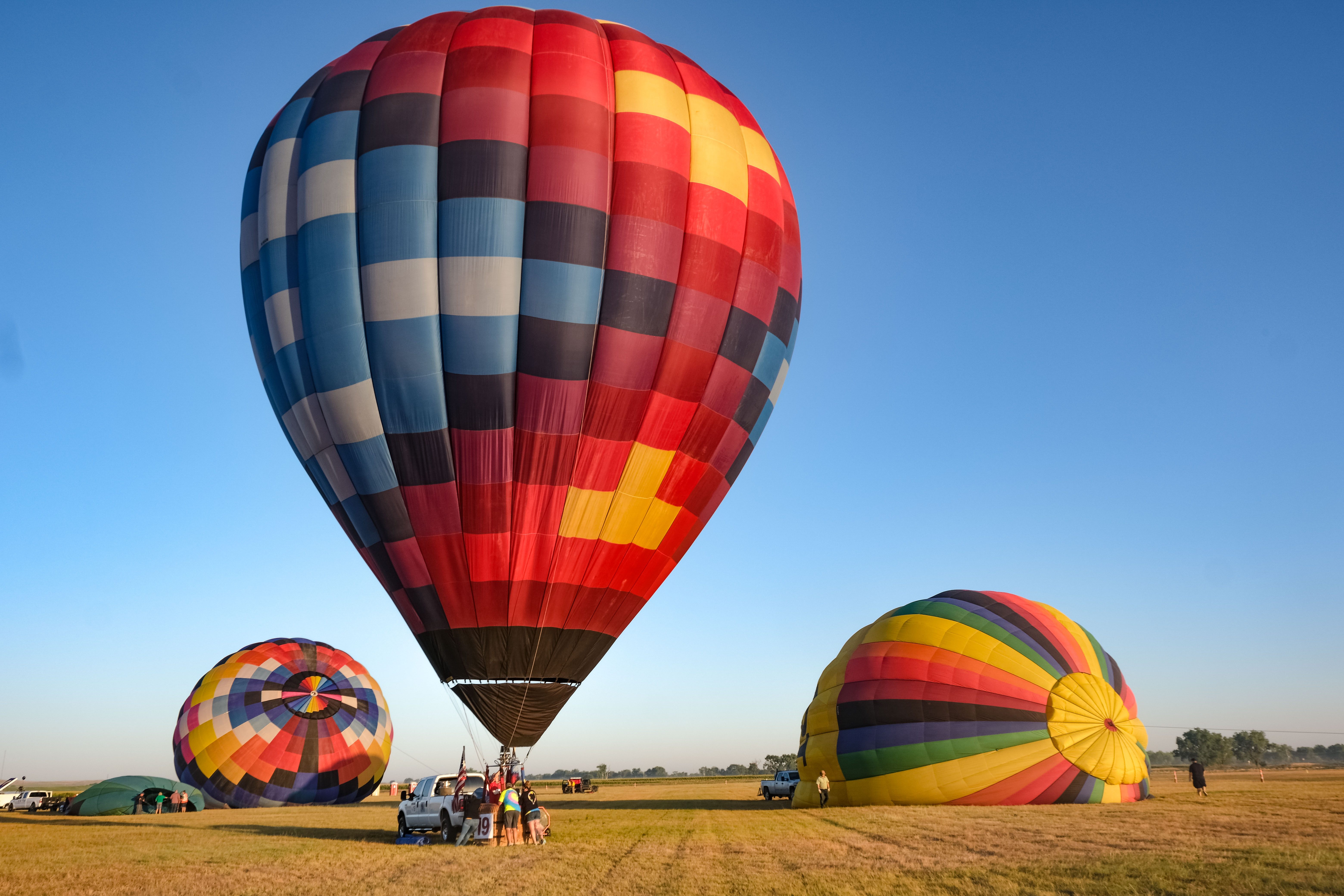 A pilot inflates their balloon for launch time.