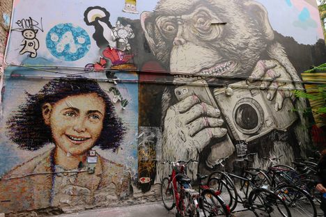 Anne Frank by Jimmy C, next to an ape holding a phone and a camera