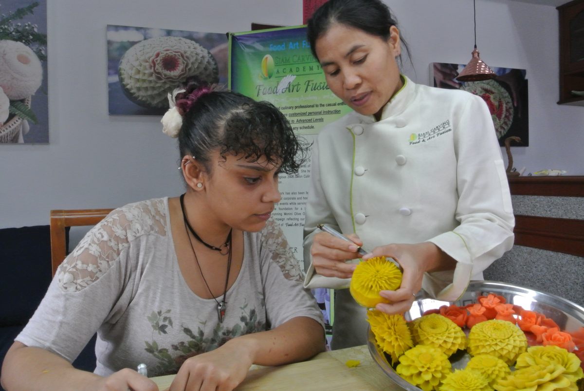 Once a carver for hotels, Wan Hertz now runs her own carving school.