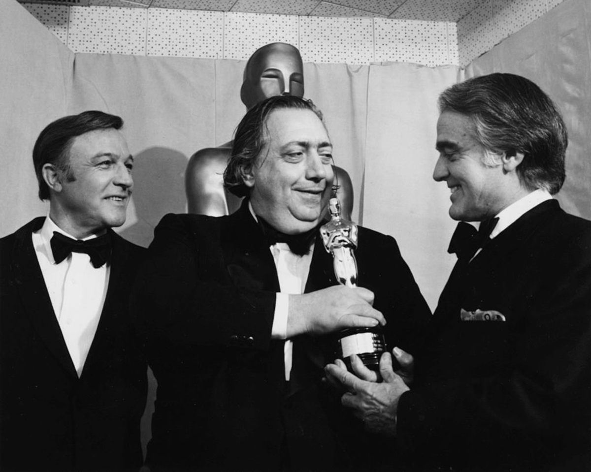 Henri Langlois holding his Honorary Oscar, with presenters Gene Kelly and Jack Valenti, at the 46th Academy Awards in 1974.