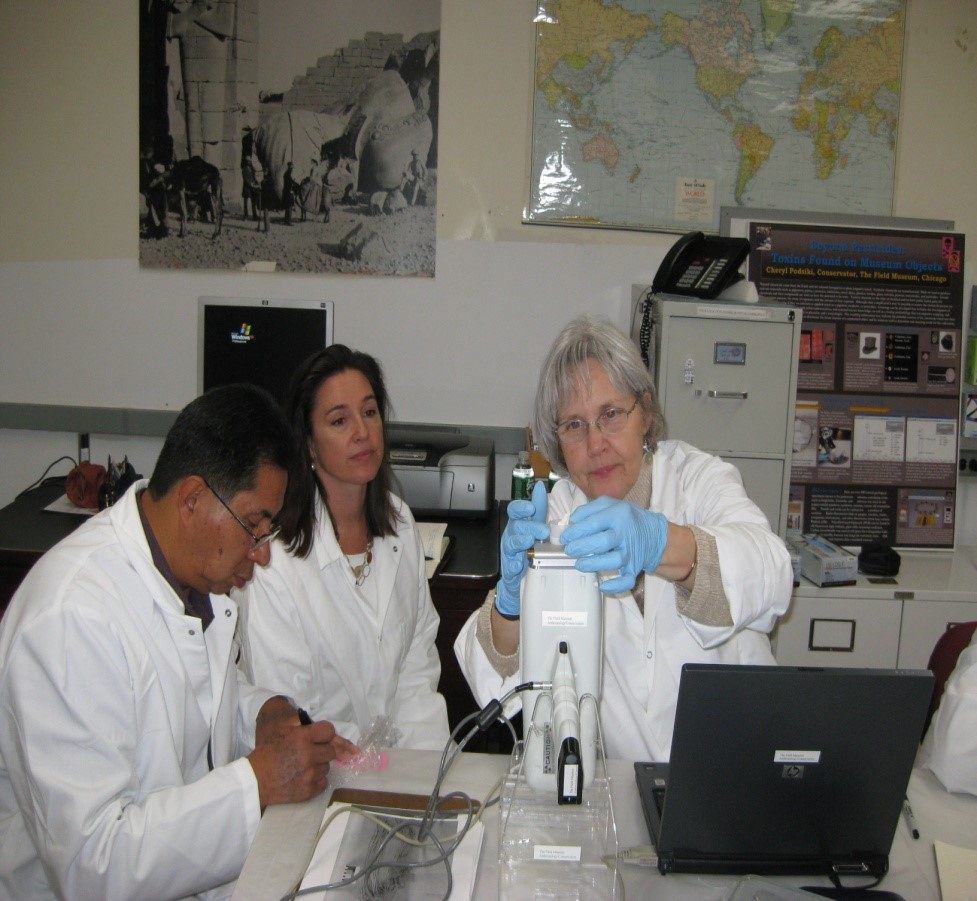 Octavius Seowtewa, a traditional leader from the Pueblo of Zuni, works to test pigments alongside the attorney Susan Benton (middle) and the conservator Cheryl Podsiki (right). The work was partially funded by a National Park Service grant.
