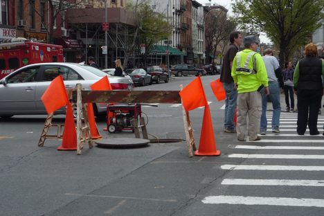Manhole cover in busy Brooklyn intersection - the only way in