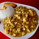 A plate of guatita, with rice and plantains. 