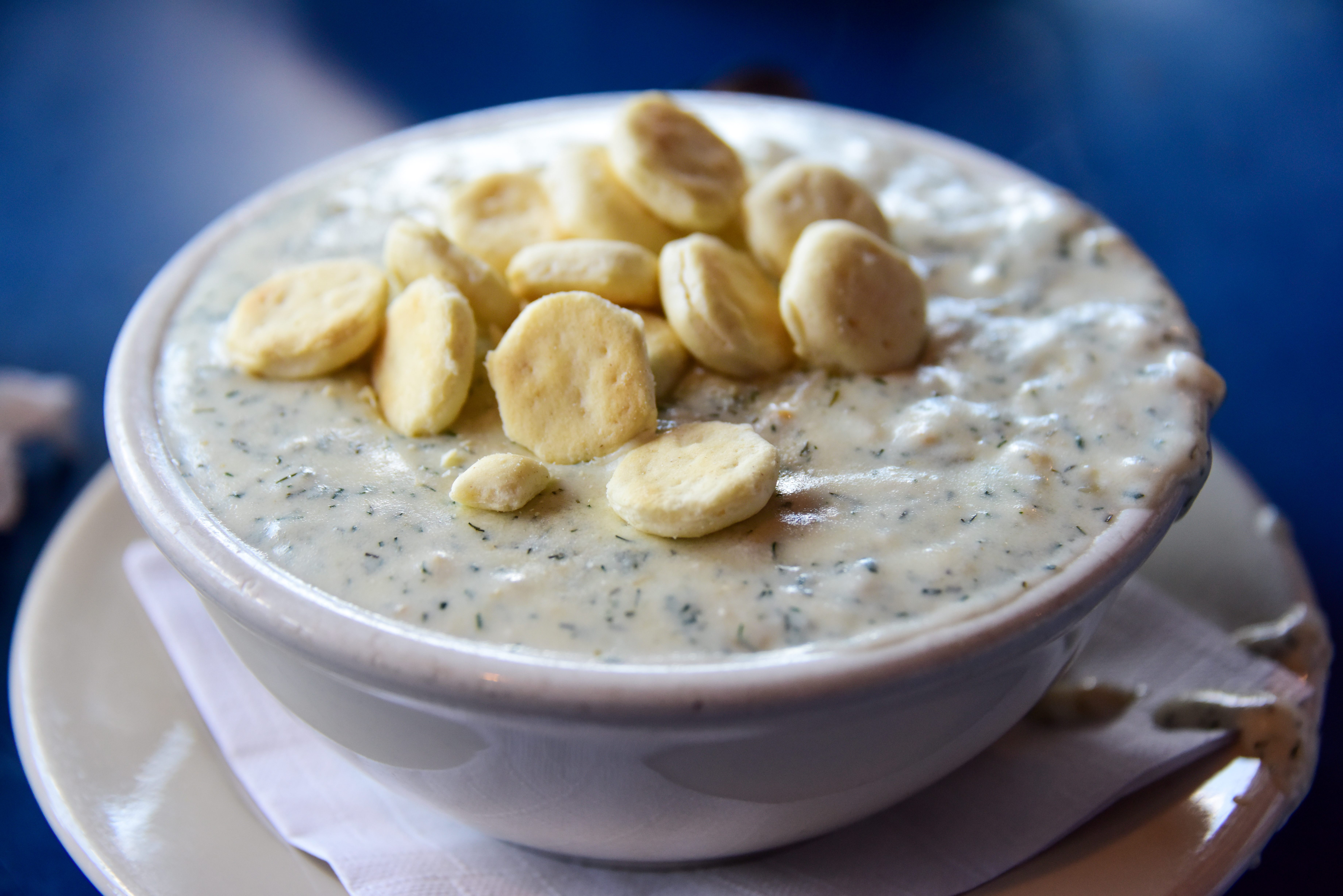A typical bowl of clam chowder, topped with oyster crackers.