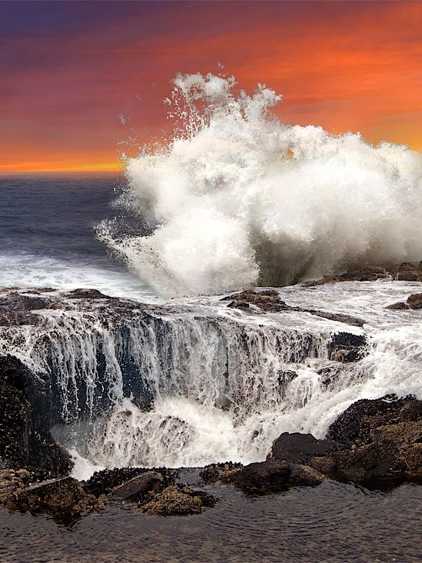 Waves crash against the rocks near Thor's Well in Oregon.