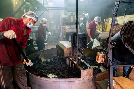Workers at Kim Guan Guan separate the sugar-coated beans before they cool.