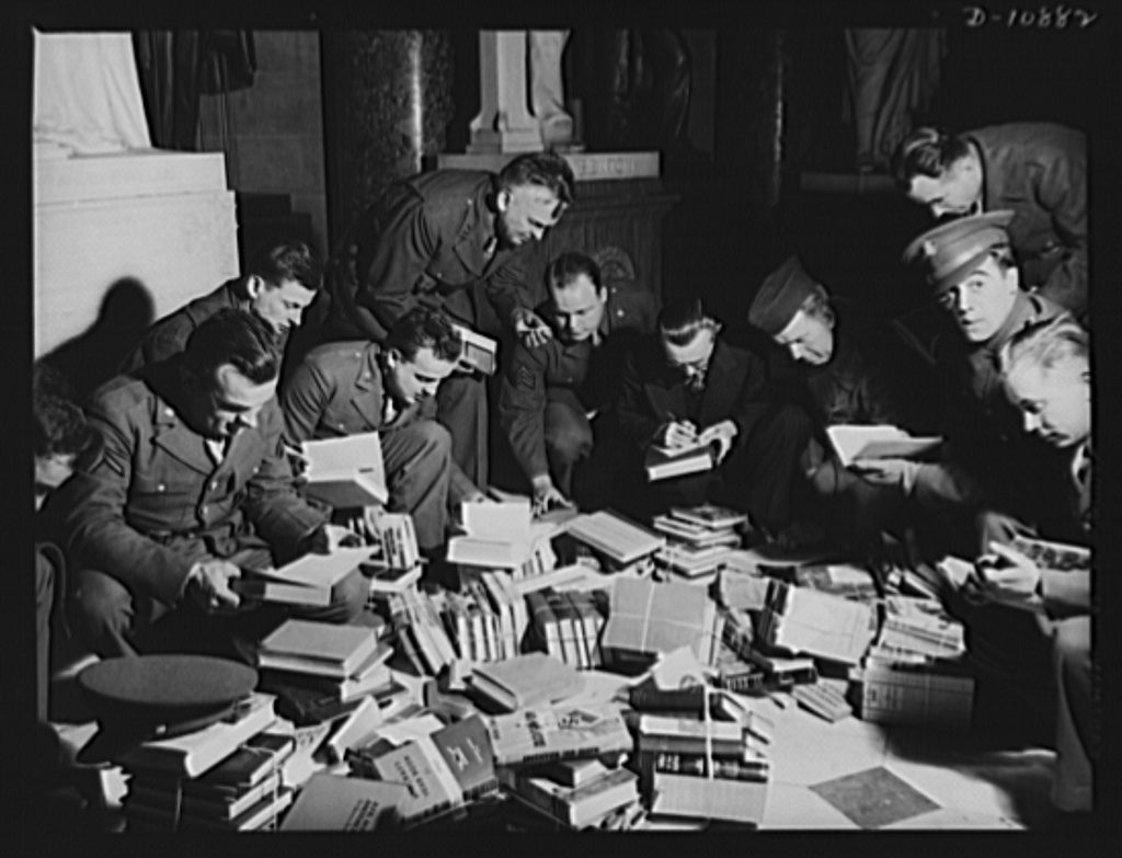 Soldiers in Virginia wrangle with hardcover books donated through the VBC.