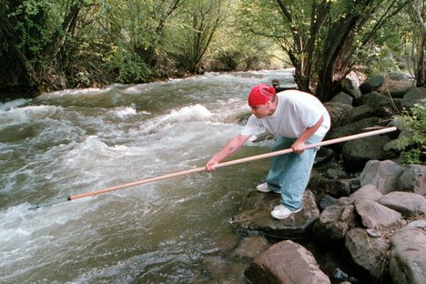A member of the Nez Perce, Brian J. Pinkham, dipnets for Chinook salmon in Idaho in 2001. For the past several years, the tribe's climate change coordinator, Stefanie Krantz, has been conducting a vulnerability assessment and working on a climate adaptation plan.