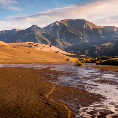 The creek lays at the feet of a series of dramatic sand dunes.