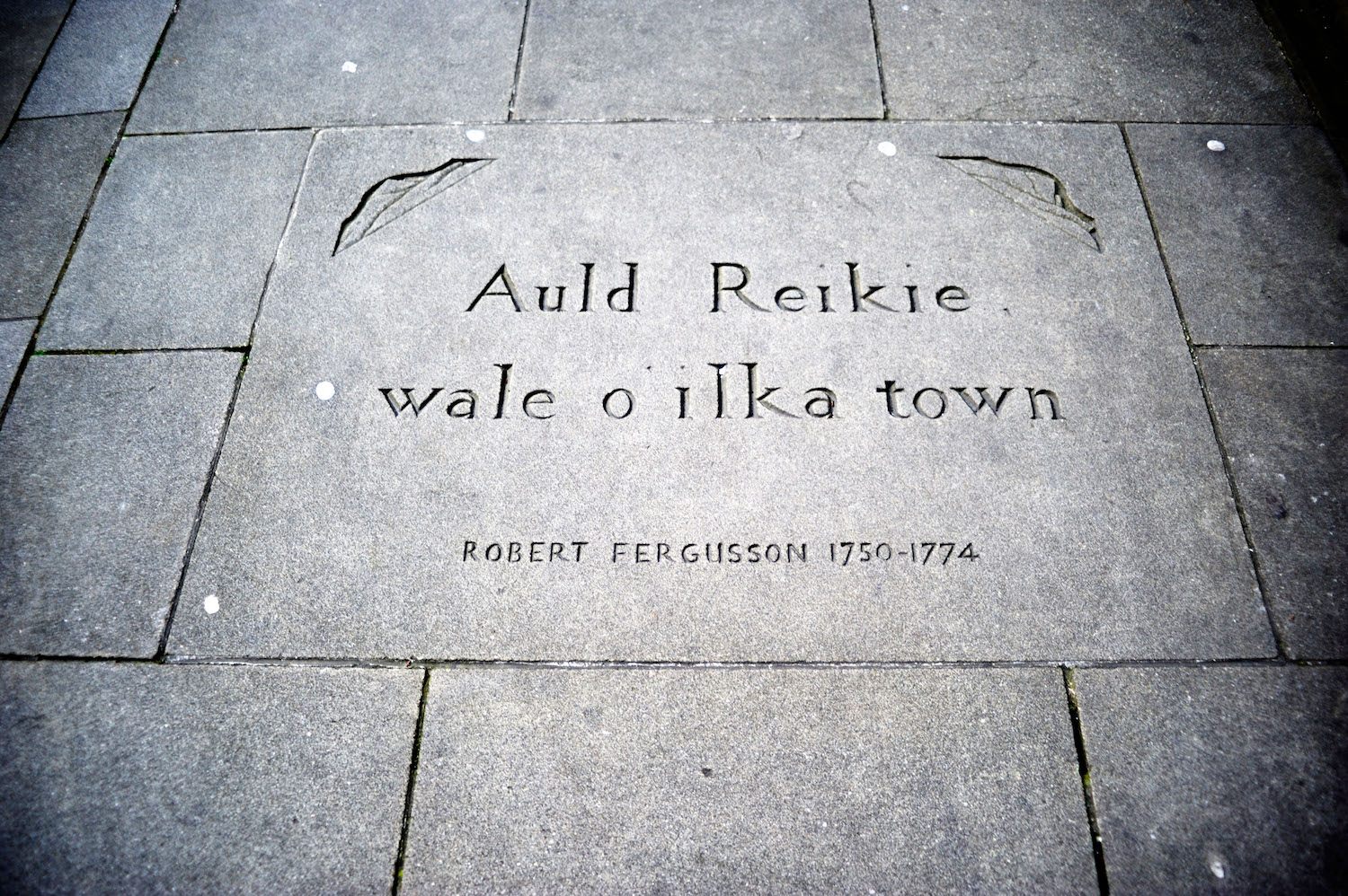 A quote from poet Robert Fergusson engraved into the sidewalk in Edinburgh.