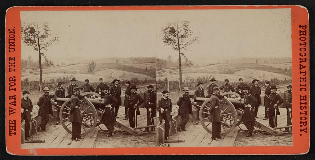 Major General William T. Sherman, center, leaning on the breach of a cannon, with his staff at Federal Fort No. 7 near Atlanta, Georgia.