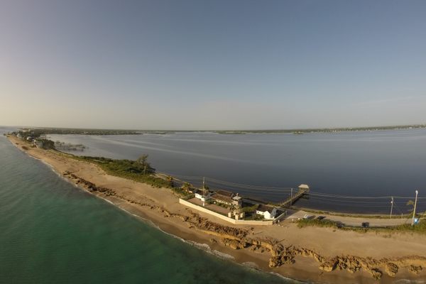The house sits on a thin sandbar off the Florida coast.