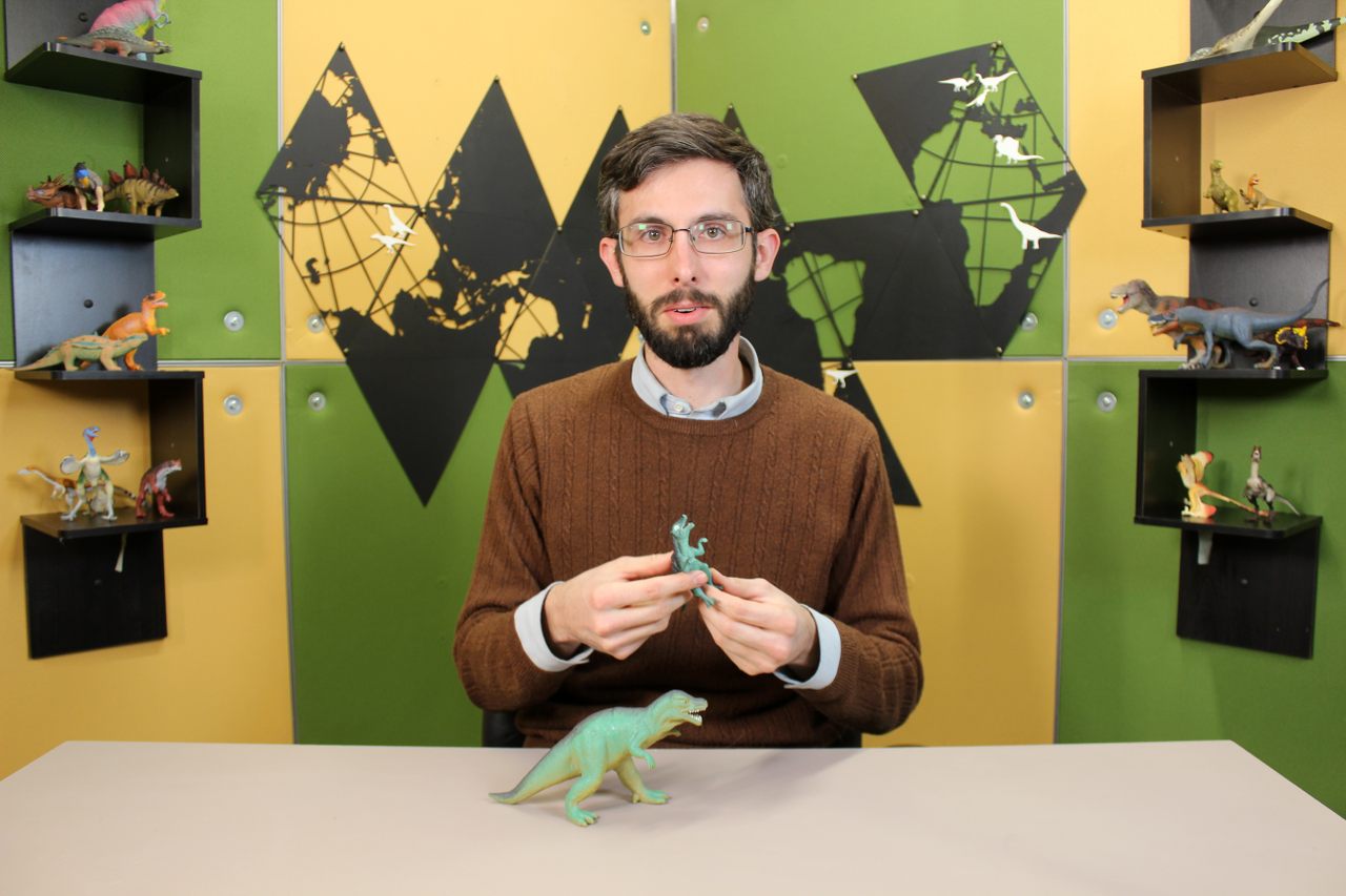 Steven Bellettini's explanations of dinosaur science start with correcting plastic toys.