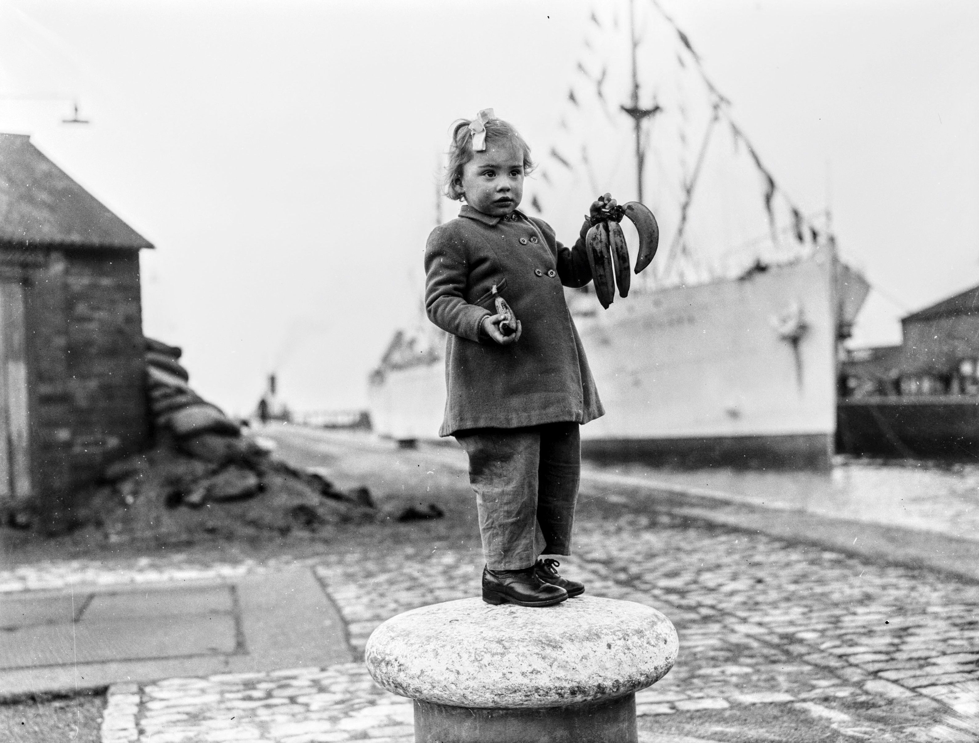 Children were the lucky recipients of the first shipment of postwar bananas.