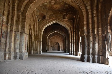 Walk through the archways of the mosque.