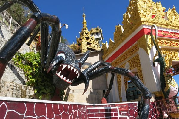 A giant spider marks the entrance to Shwe U Min Pagoda.