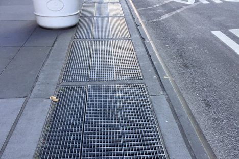 A daytime view of the grate, looking north on Lexington Avenue towards the corner of 52nd Street. 