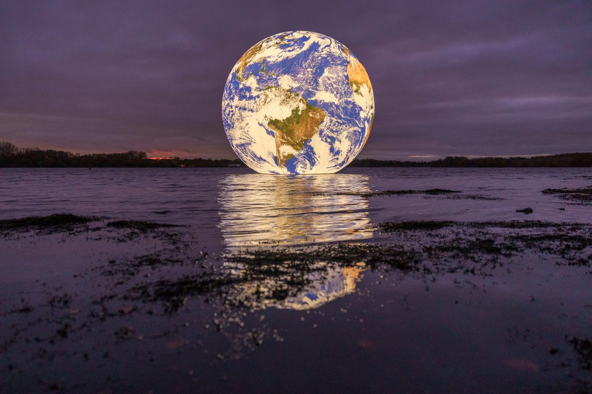 Artist Luke Jerram's <em>Floating Earth</em>, a replica of our planet measuring 32-feet in diameter, floats for the first time, on an open expanse of water in Wigan, England, on November 18, 2021. 