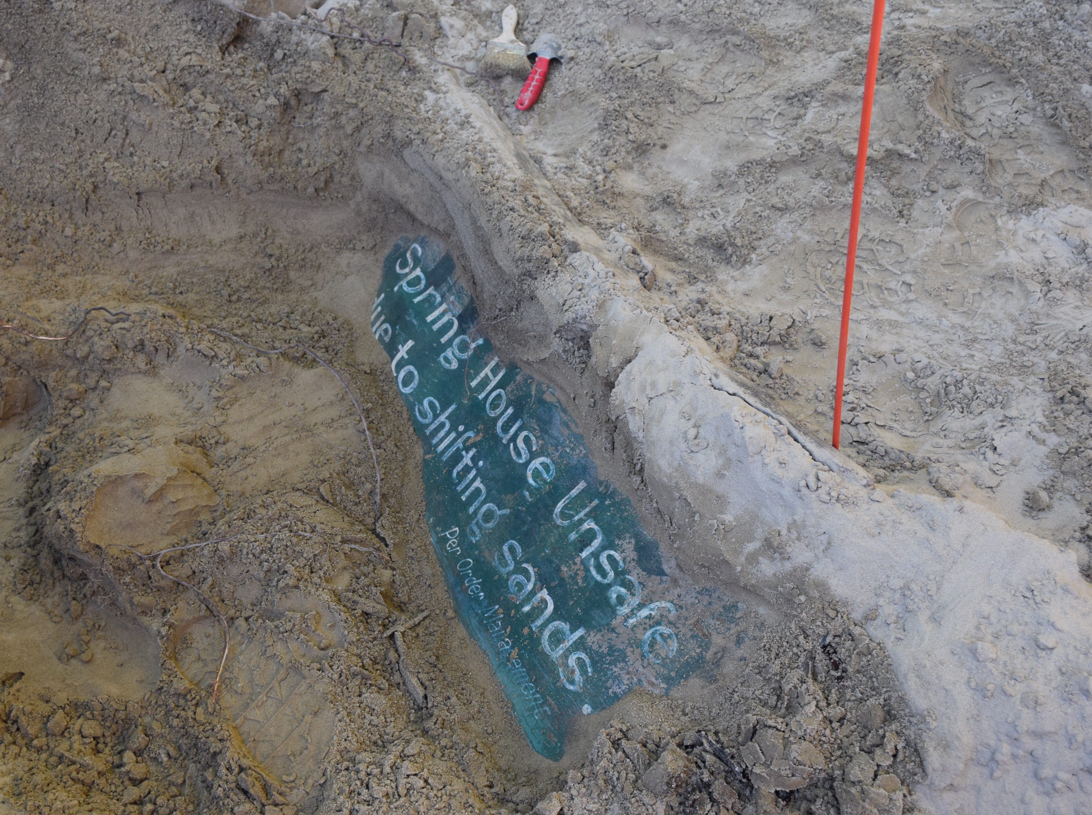 Saat menggali, kru menemukan tanda teal tua yang memperingatkan pengunjung untuk menjauh dari struktur, yang dibuat tidak sehat oleh serangan pasir.