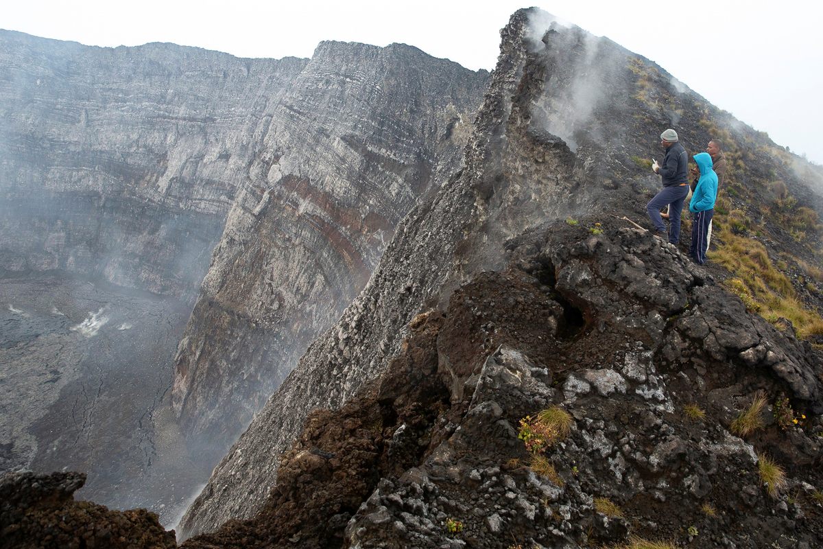A team from the Goma Volcano Observatory looks down into the crater on Nyiragongo in February 2021.