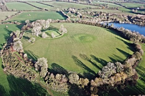 The hilltop remains of Navan Fort, an Iron Age site that a new paper argues has a broader history than previously thought.