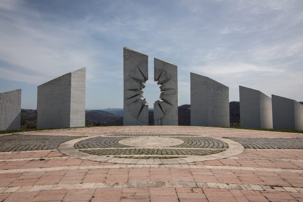 A stylised bullet hole decorates a concrete pylon