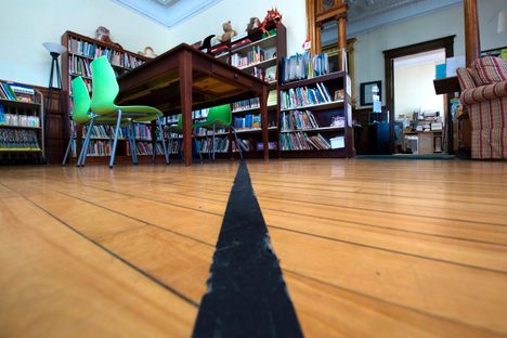 Black tape marks the U.S./Canada border inside the Haskell Free Library and Opera House.