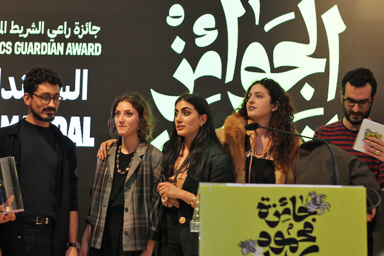 Joseph Kai and Nour Hifaoui Fakhouri (from left), alongside other Samandal artists, receive the Comics Guardian Award from American University of Beirut in 2019. 