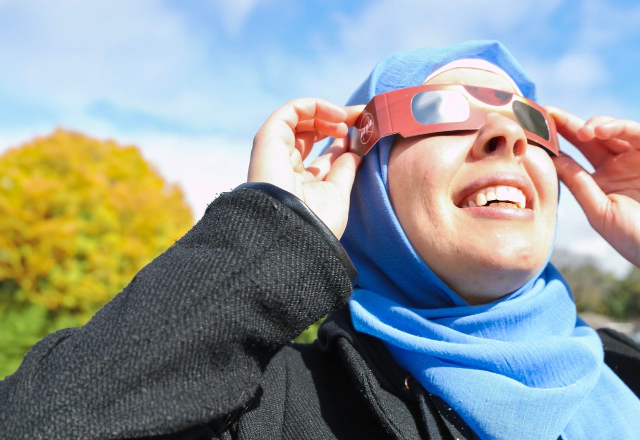 NASA/JPL Solar System Ambassador Nadia Abuisnaineh gazes up at the 2023 partial eclipse.