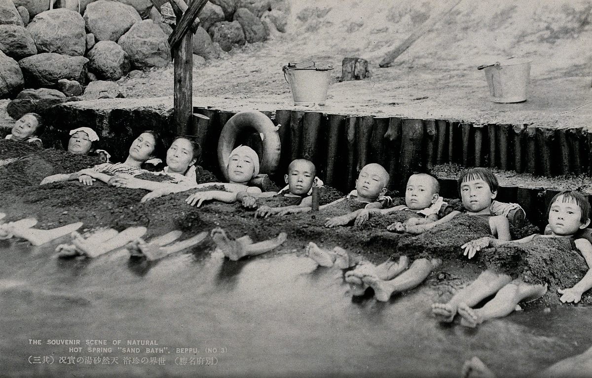 Bathing in the hot springs' sands (here, circa 1930) has drawn tourism since the Edo period.