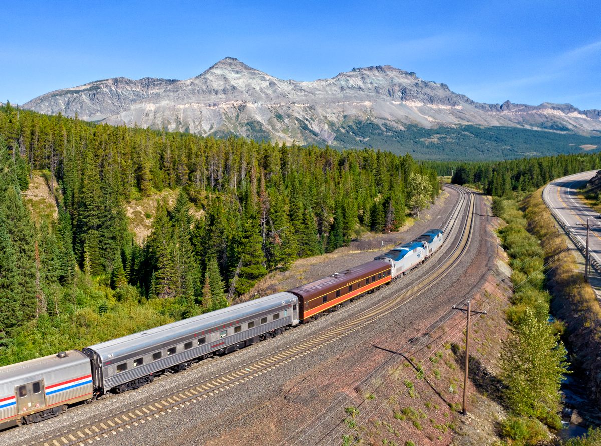 Two private railcars, the Blue Ridge Club and Pacific Home, cross the Continental Divide at Marias Pass, Montana, on the southern edge of Glacier National Park. 
