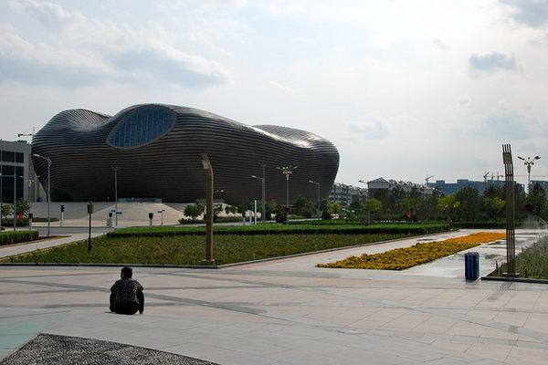A lone man sits near the museum in Kangbashi.