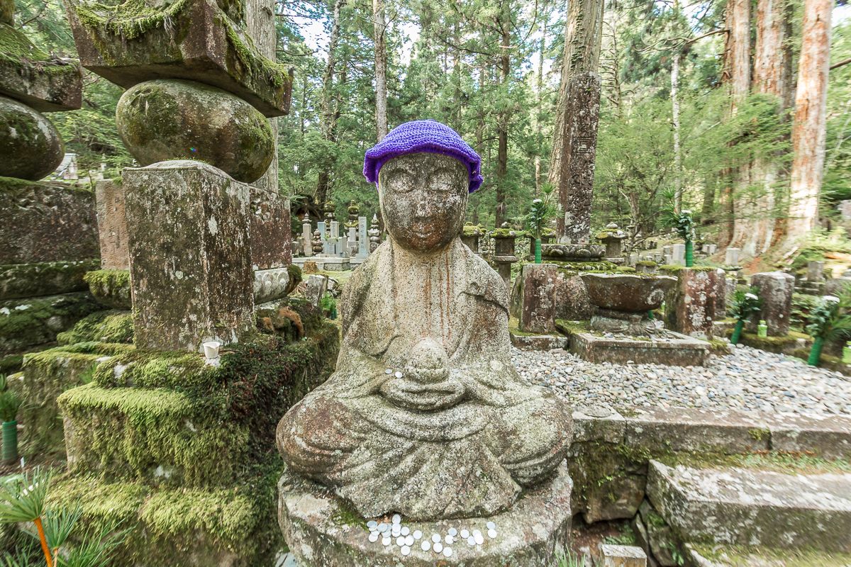 A typical lotus pose for a Jizo, capped in the less-common color of purple.