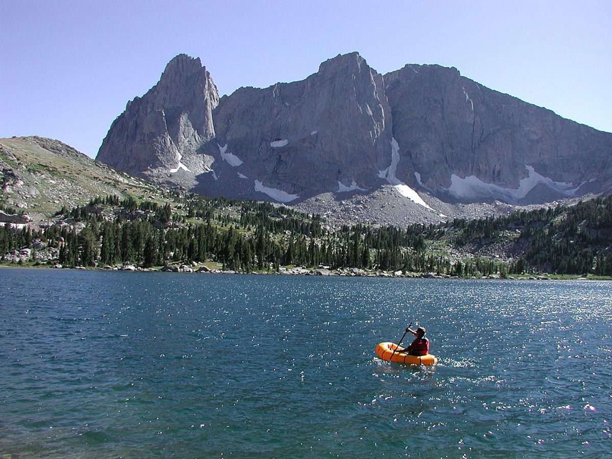 A field biologist in a raft during a fish population survey.