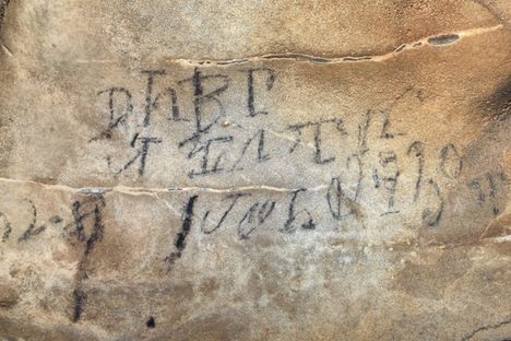 The inscription reads, "leaders of the stickball team on the 30th day in their month April 1828." The use of "their" refers to the Euro-American concept of time. 