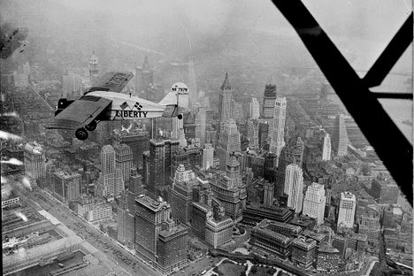 “Liberty bellanca monoplane in the air (over N.Y.C.) on first leg of its flight to Denmark. From Hasbrouck Heights, N.J. with Otto Hillig of Liberty, N.Y., flying photographer and Capt. Hoérüs, the pilot”