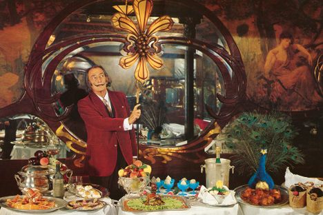 Salvador Dali at one of his lavish dinners. Some of the dishes featured in the photograph appear in his cookbook, Les Dîners de Gala. 