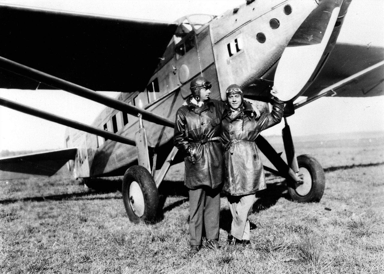 Antoine de Saint-Exupéry (left), Aéropostale pilot and author of <em>The Little Prince</em>, stands in front of a plane in 1929.